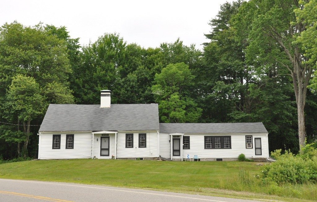 The yellow McClure-Hilton House in Merrimack, New Hampshire, a two-story colonial with white trim