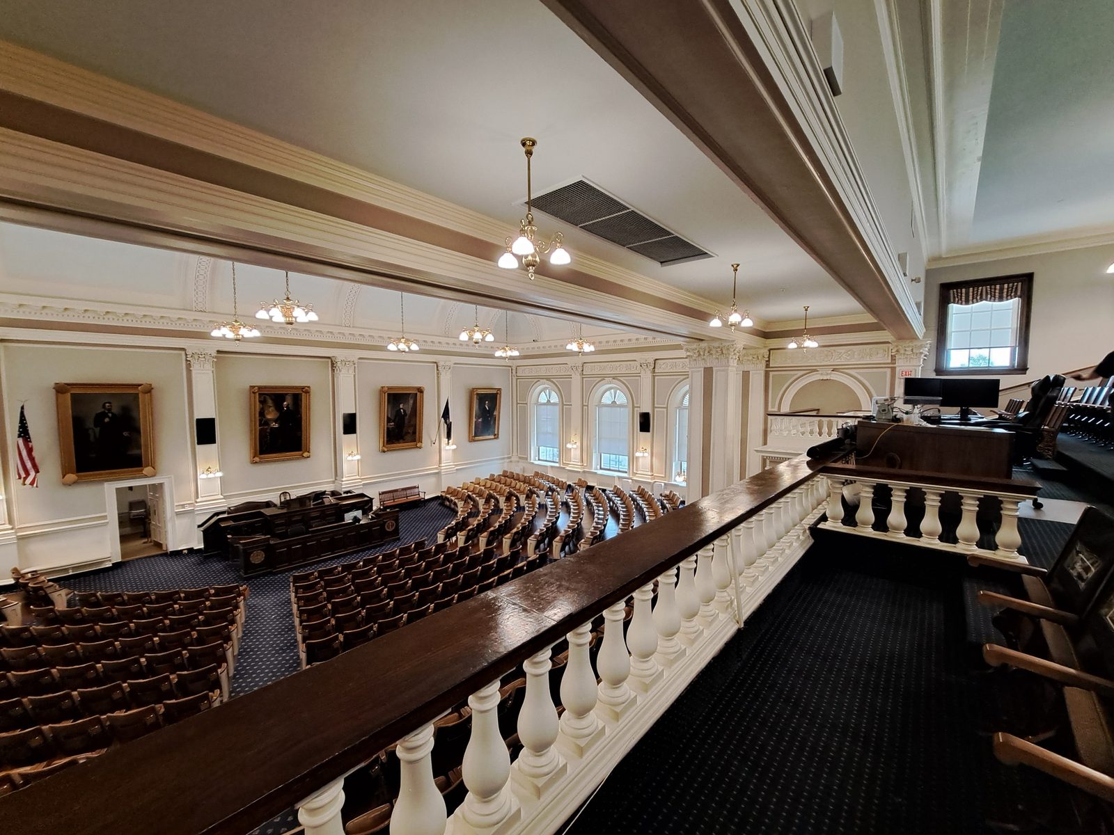 The New Hampshire House of Representatives chamber in Concord, with curved rows of desks facing the speaker’s rostrum